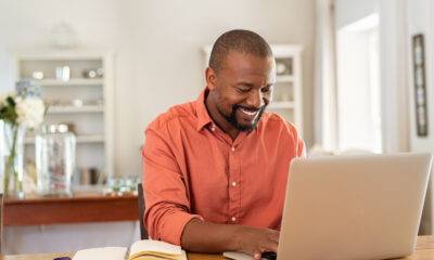 Best Remote Jobs in the USA: A man happily working remotely from his home