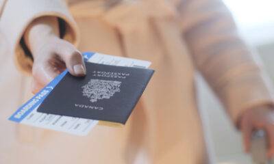A Comprehensive Guide to Canada Tourist Visa: A Lady with a passport and flight ticket