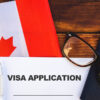 Canada visa for people living in Saudi Arabia: Image of a visa application form and flag in Canada.