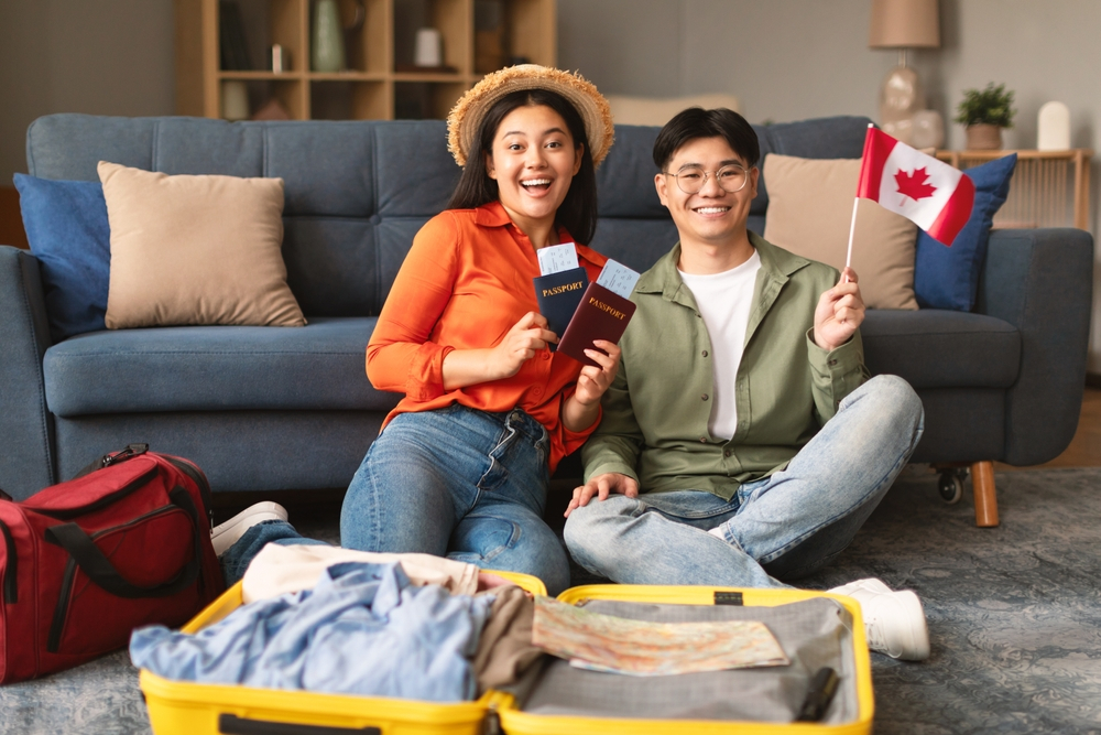 Canada Spouse Visa Processing Time: A picture showing Canada couple holding flags and passports.