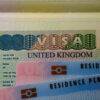 Jobs that can get you a UK Visa: UK BRP (Biometrical Residence Permit) cards for Tier 2 work visa placed on top of UK VISA