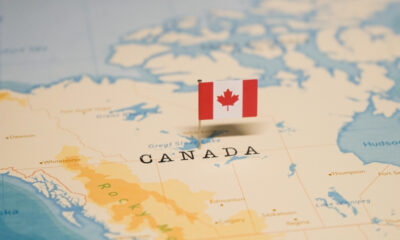 Canada Visitor Visa: A picture showing Canadian flag on the country's map.