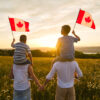 Canada Family Reunion Visa: A picture showing a couple with their kids holding Canadian flags.