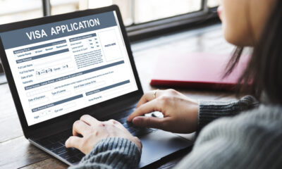 Mistakes People Make When Applying for a UK Visa: A picture showing a UK visa applicant filling out application forms.