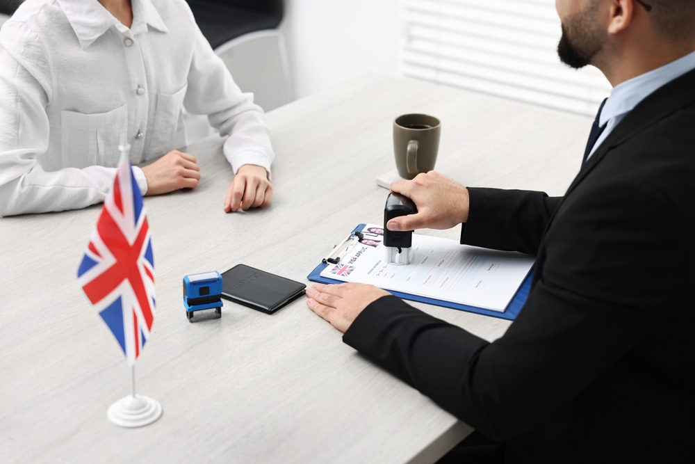 Mistakes People Make When Applying for a UK Visa: A picture showing a UK Visa applicant before consular officer.