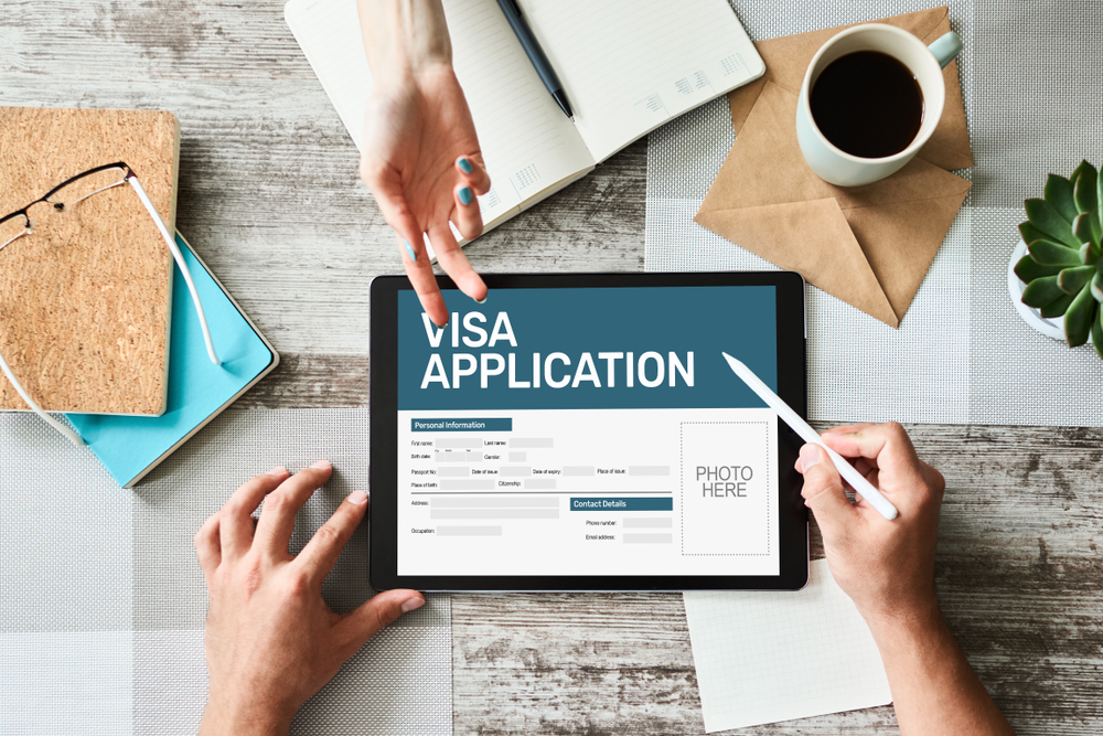 Things to Avoid During the UK Visa Application Process: A picture tab on the table with visa application displaying.