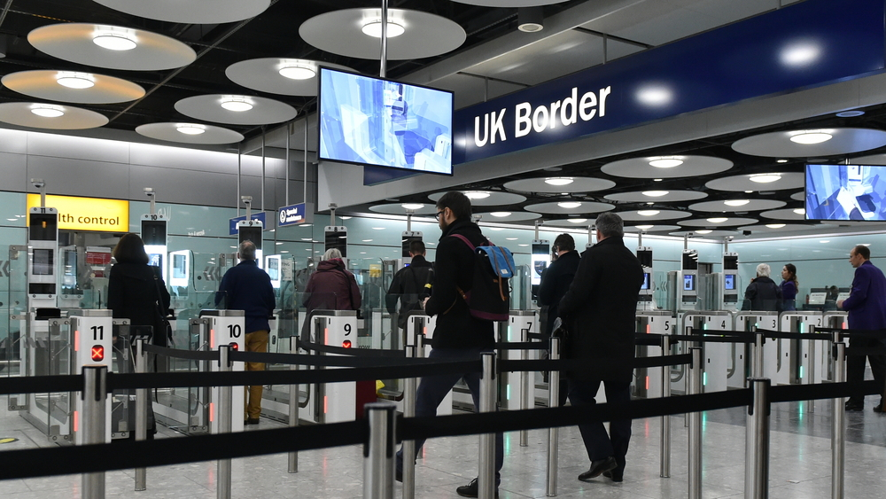 How to Avoid UK Visa Rejection: A picture showing Visa applicants at the UK immigration checking point, entering the country.