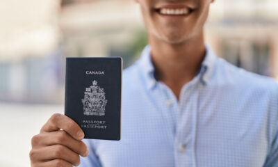 Canada Citizenship: A picture showing a man displaying Canada passport.