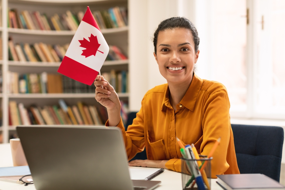 Canada Visitor Visa: A picture showing a lady holding Canadian flag after securing Canada citizenship.