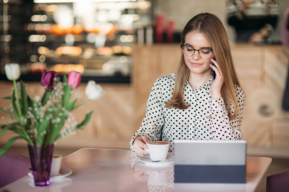 Secrets to Maintaining Work-Life Boundaries in a Remote Job: A female freelancer on a phone call and working from home