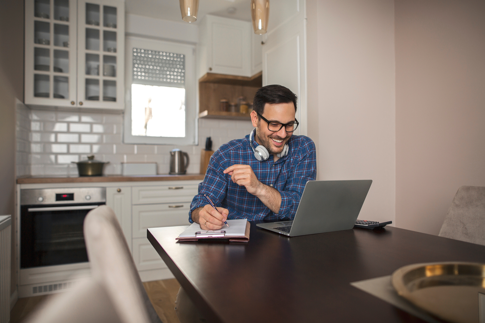 Things Not to Do When Applying for Remote Jobs: A male freelancer working remotely on a laptop. 