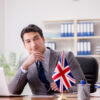 What Not to Do When Negotiating a Job Offer in the UK: Businessman with British flag in the office