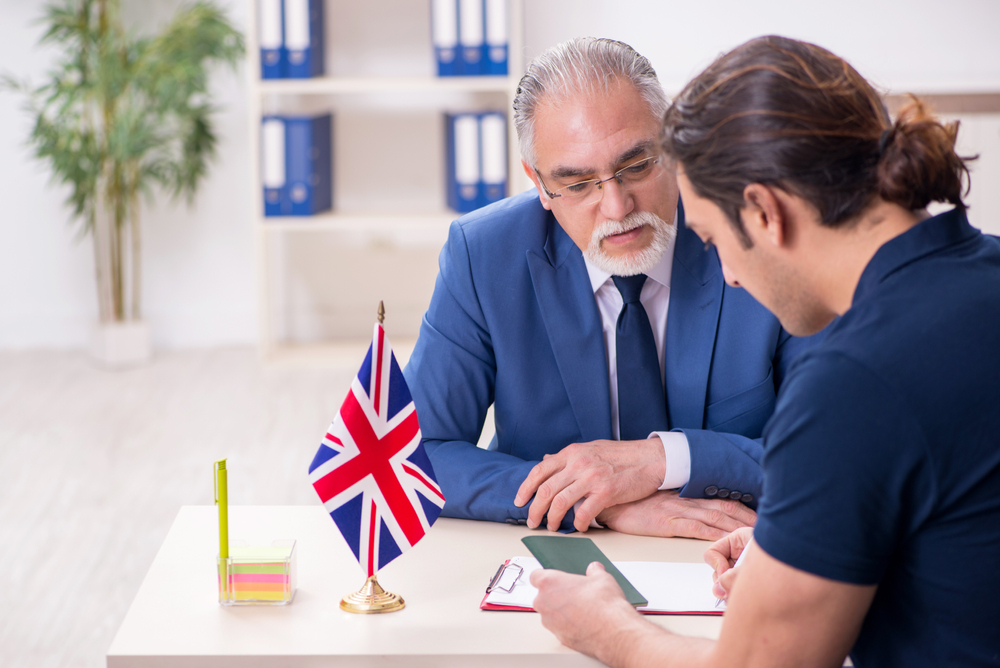 7 Secrets to Acing Your UK Work Visa Interview: Young man visiting embassy for visa application.