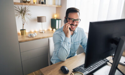 Proven Strategies to Avoid Distractions When Working Remotely: Smiling handsome freelancer working remotely from home.