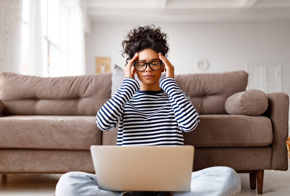 How to Avoid Burnout When Working Remotely: Picture of a lady experiencing burnout for working remotely