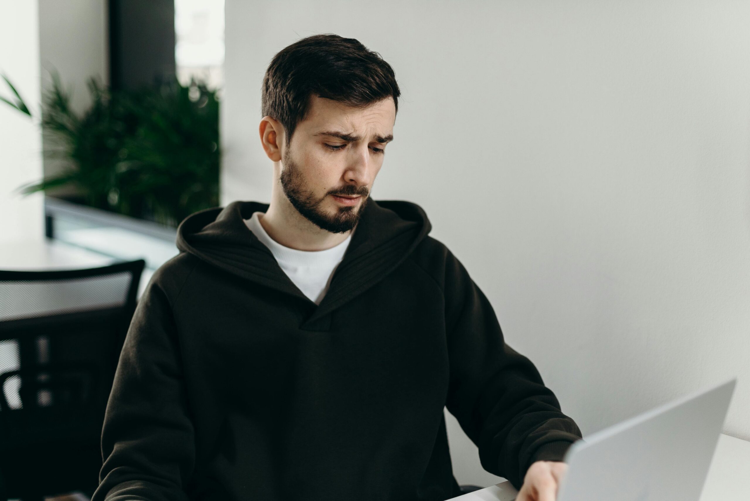 The Biggest Mistakes People Make When Interviewing for Remote Positions: A male freelancer working on a laptop from home.