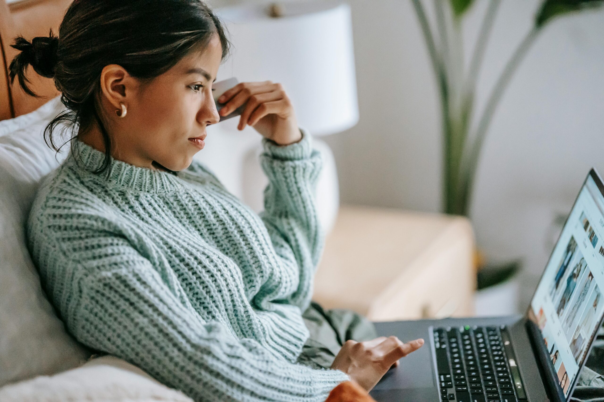 How to Avoid Remote Work Scams When Searching for Remote Work: A female freelancer working remotely on a laptop 
