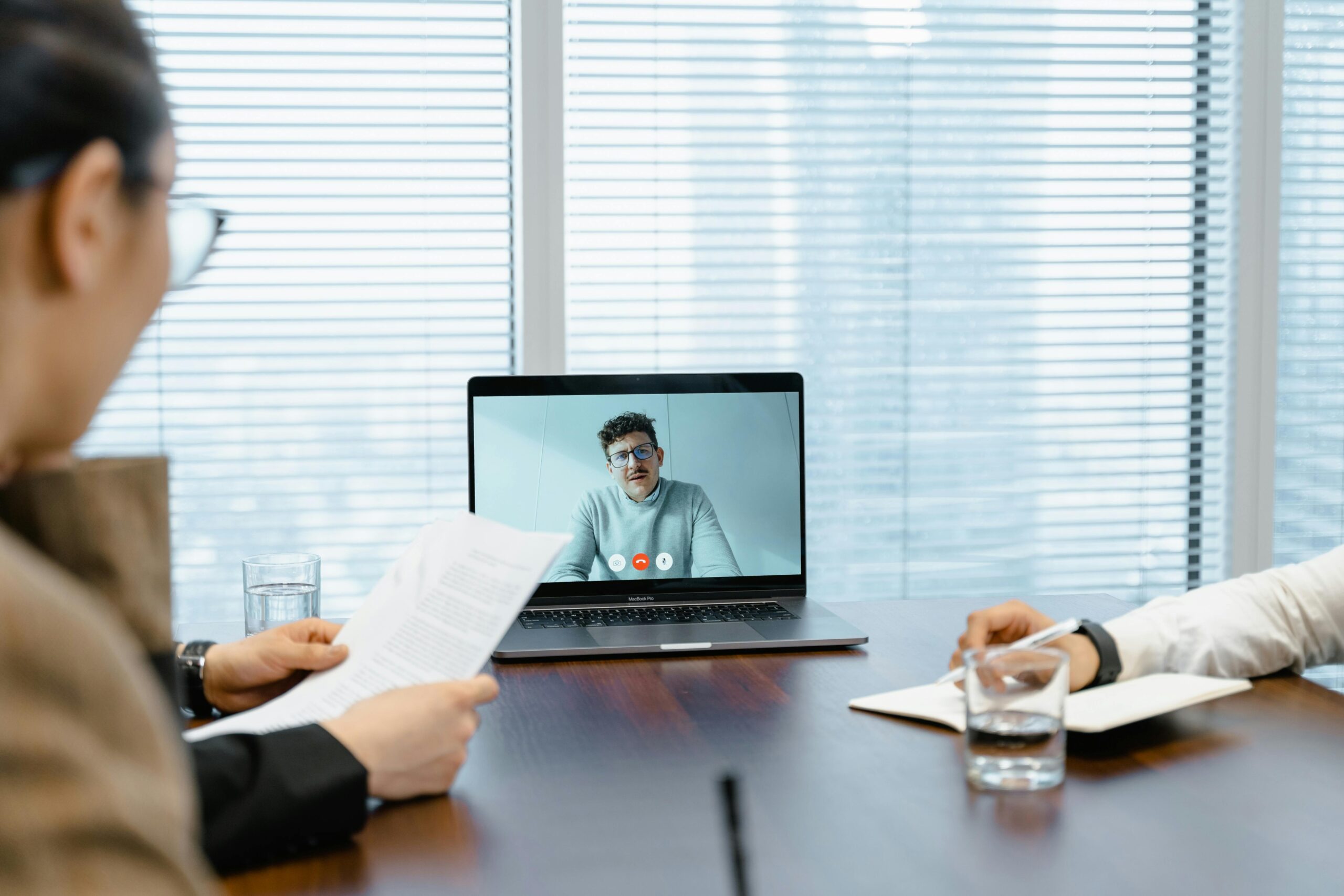 The Ultimate Guide to Acing Your Remote Job Interview: Image of a man in a virtual interview meeting. 