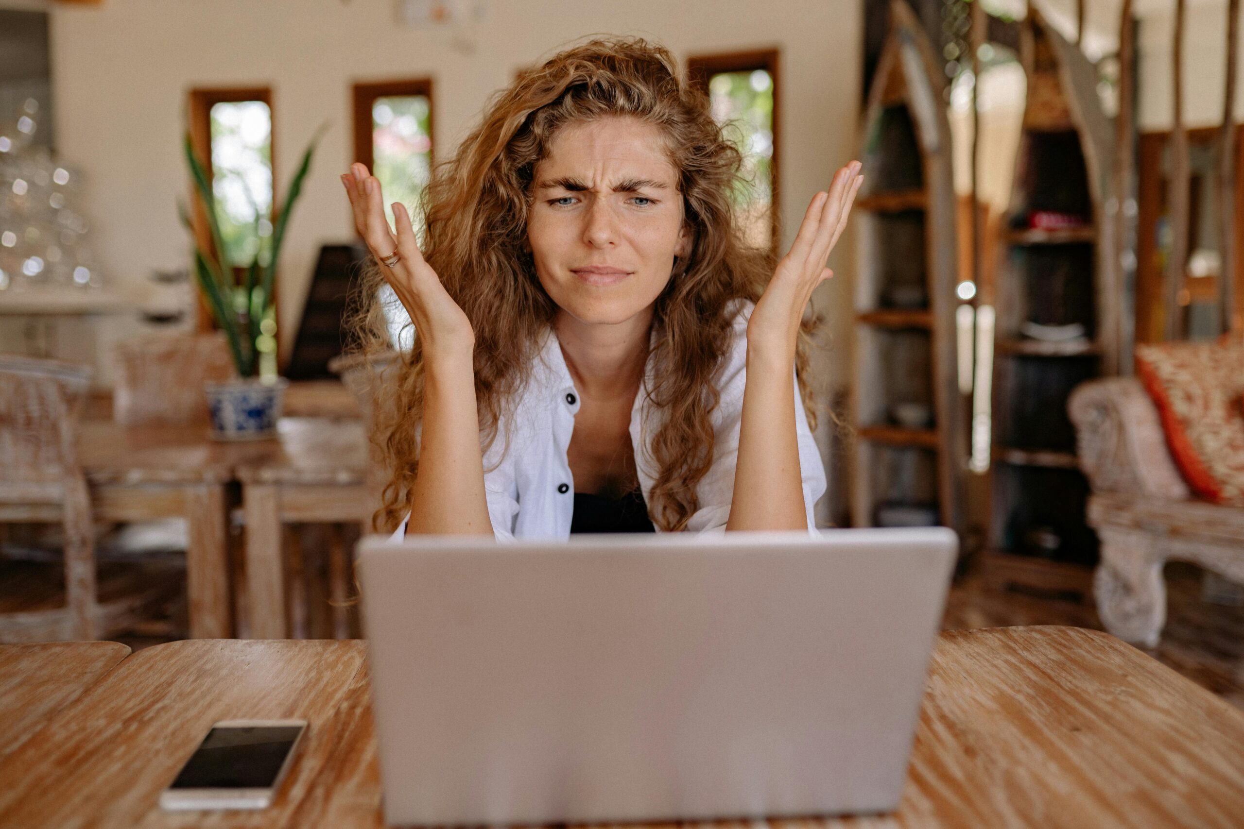 Work from Home Pitfalls and How to Avoid Them: Picture of a lady feeling isolated and worried. 