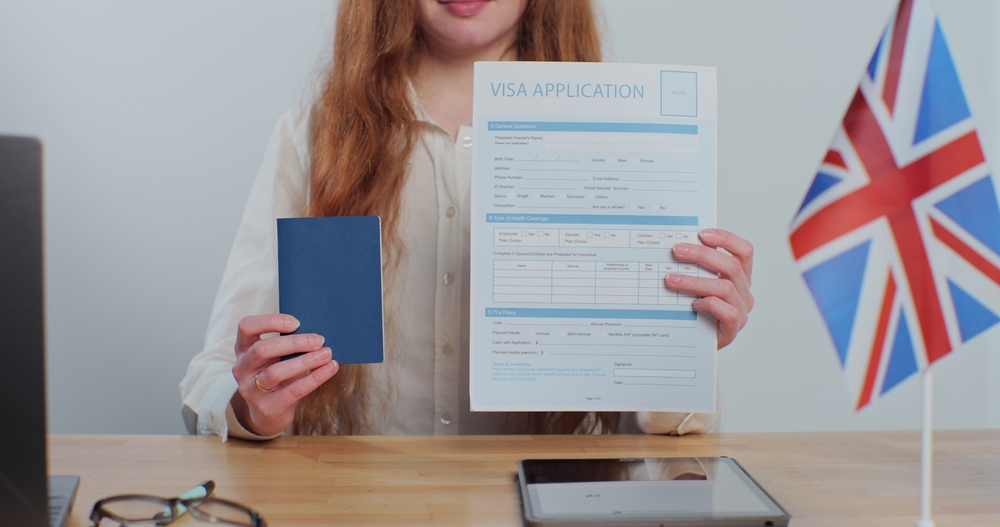 In-Person vs Virtual UK Visa Appointments: British embassy woman officer showing visa application and passport, legal immigration, tourist interview. 