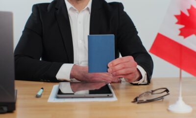 Canada Work Visa Pitfalls: Canadian man consular officer showing passport immigrant, work visa, citizenship.