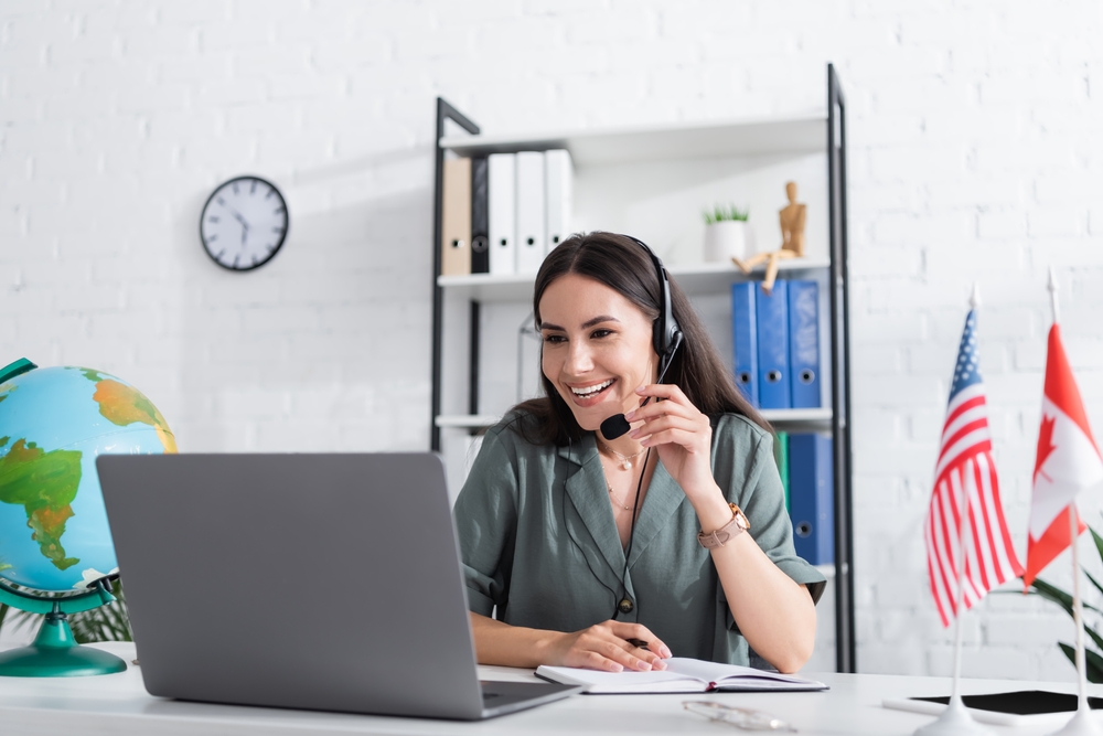 Working in Canada vs Working in the US: Picture of a positive worker in her office