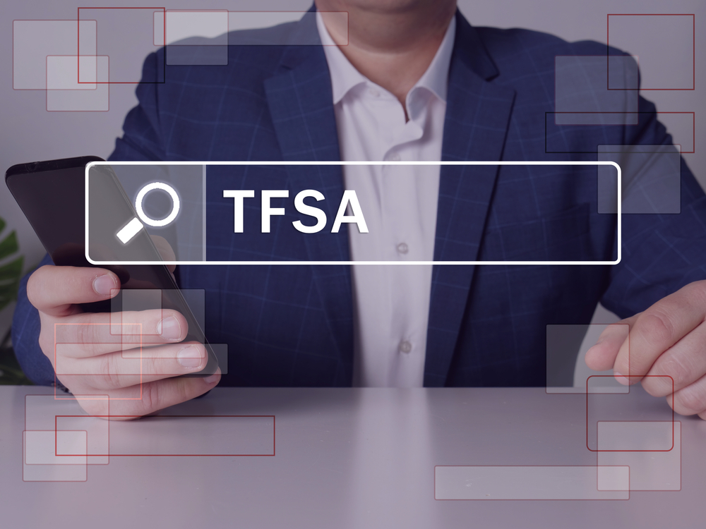 Tax-Free Savings Accounts (TFSAs) For Newcomers in Canada: Canadian Tax-Free Savings Account: Tax-Free Savings Account TFSA phrase on the screen. Loan officers use cell technologies at the office. 