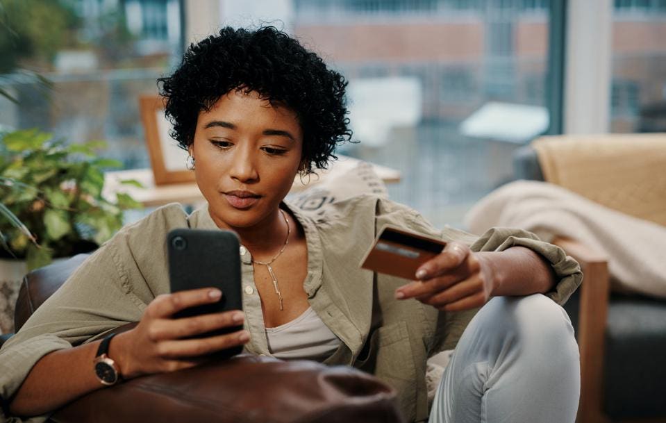 How to Build Credit as a New Immigrant in Canada: Picture of a lady using credit card