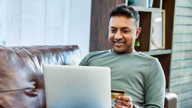 How to Build Credit as a New Immigrant in Canada: Picture of a man using credit card